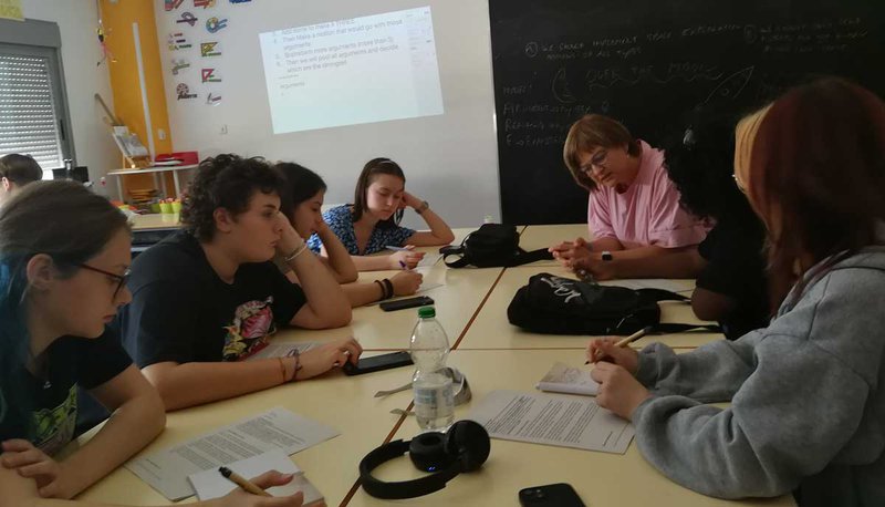 Teacher with a group of students at the table